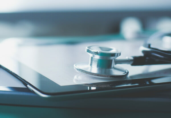 Medical equipment: blue stethoscope and tablet on white background. Medical equipment.